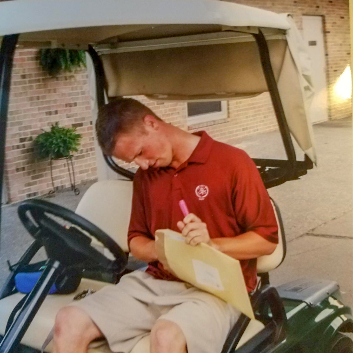 Zach Olsen opening his Evans Scholarship offer as a caddie.