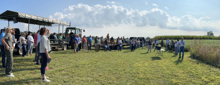 A group of people gathered around a speaker.