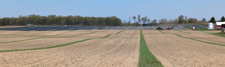 Plastic being laid in a field.