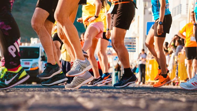 Photo of a group of runners legs and feet at a race.