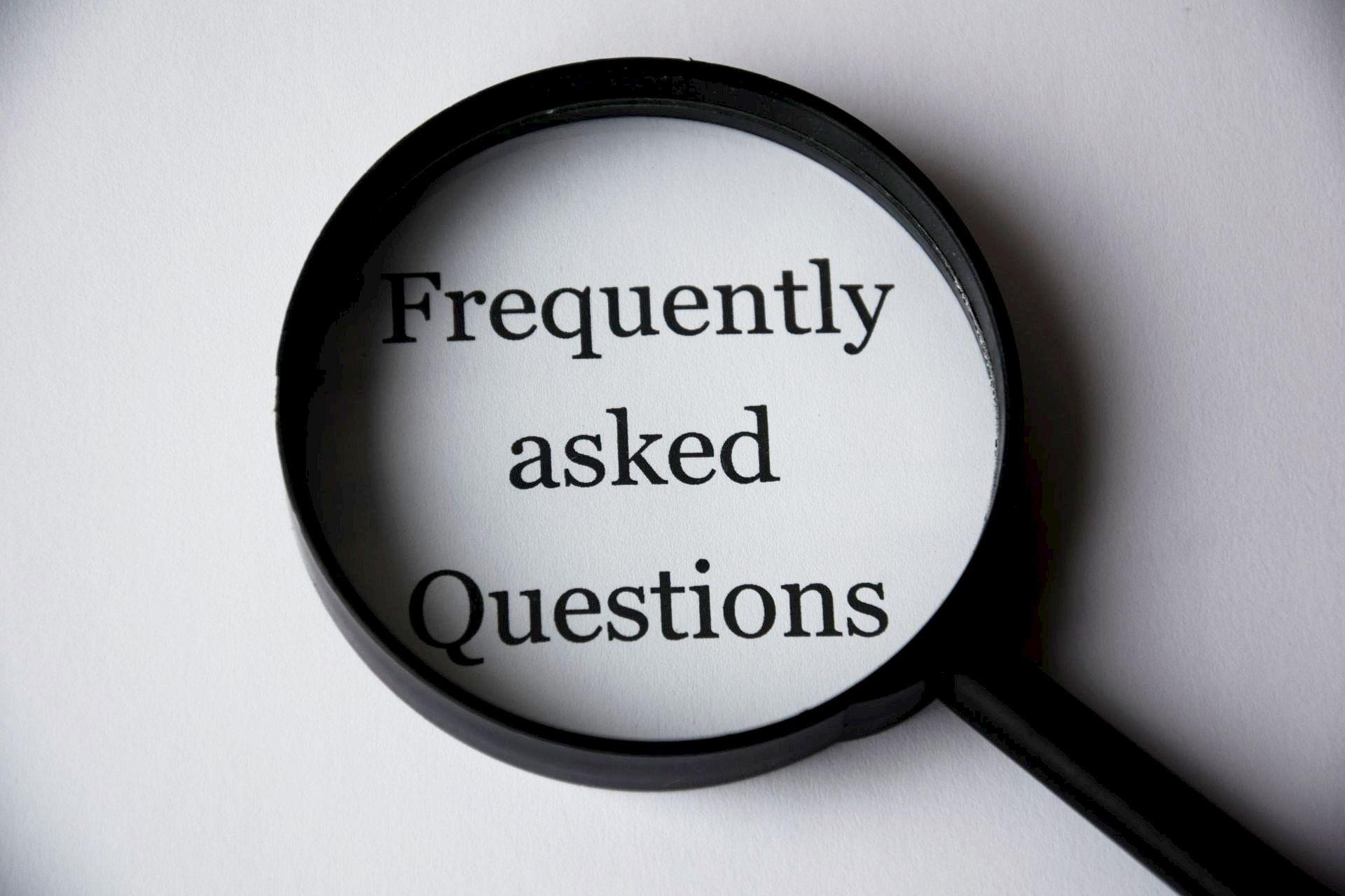 Frequently Asked Questions displayed through a black magnifying glass