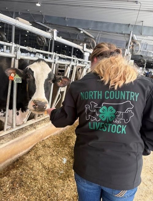 A girl with a black coat that says 