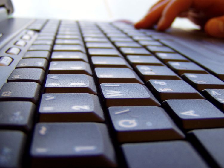 Keyboard with hands typing.