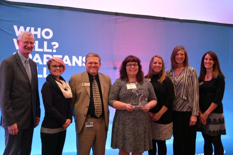 Award winners stand with director and nominators.