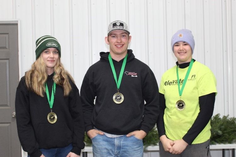 Team members Chloe Steiner, Ross Kelsey, and Lydia Deters with their first place medals around their neck.