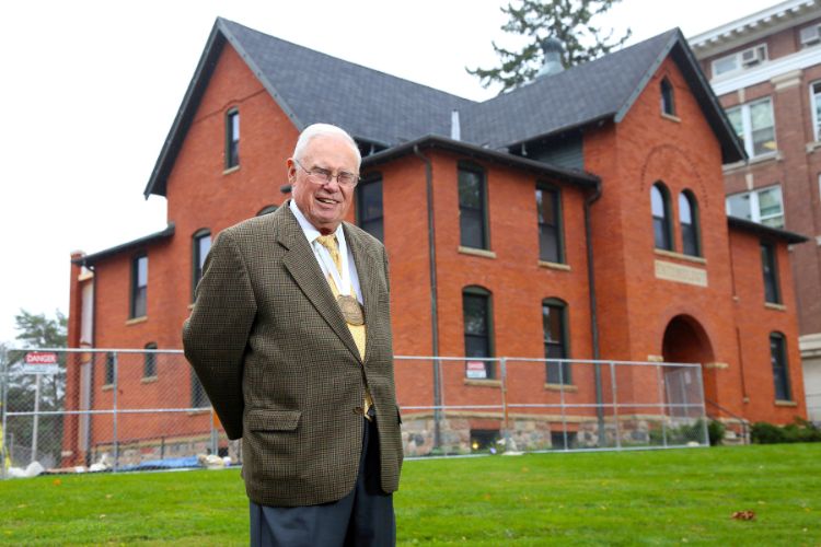 Image of Dr. Gary Seevers, Ph.D. standing in front of the newly renovated Cook-Seevers Hall.
