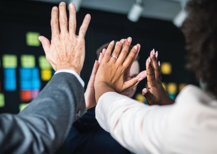 Hands coming together to depict teamwork.