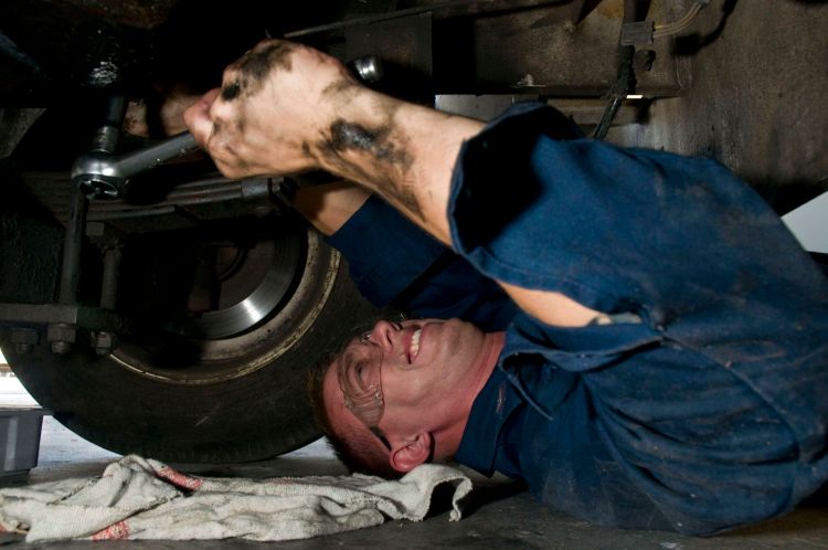 Man fixing tractor.