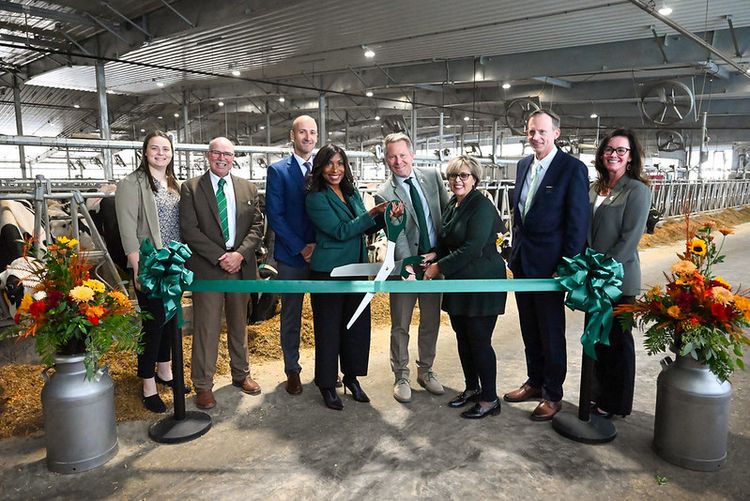 Leaders from Michigan State University and Michigan's dairy farming community cut the ribbon to dedicate the new MSU Dairy Cattle Teaching and Research Center. From left, recent doctoral recipient Lynn Olthof, Ph.D., Michigan Milk Producers Association Chairperson Doug Chapin, MSU AgBioResearch Interim Director Chad Cotti, Ph.D., MSU Board of Trustees Chairperson Brianna T. Scott, J.D., MSU President Kevin Guskiewicz, MSU Board of Trustees member Rebecca Bahar-Cook, College of Agriculture and Natural Resources Associate Provost and Dean Matthew Daum and College of Veterinary Medicine Dean Kimberly Dodd, Ph.D.