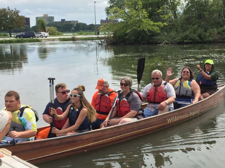 Wayne County Special Olympics athletes, friends and family return to the dock after winning a canoe race. Mary Bohling | Michigan Sea Grant