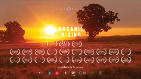 Organic Rising film poster shows a sunrise over a rural landscape with the film title and 23 film festival award banners.
