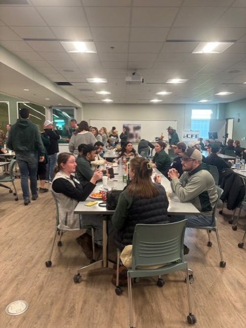 people sitting at tables talking to each other