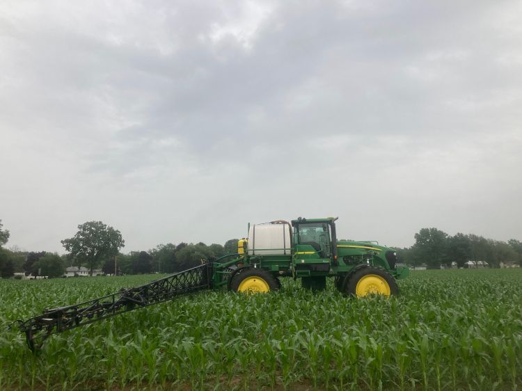 A sprayer in an agricultural field.
