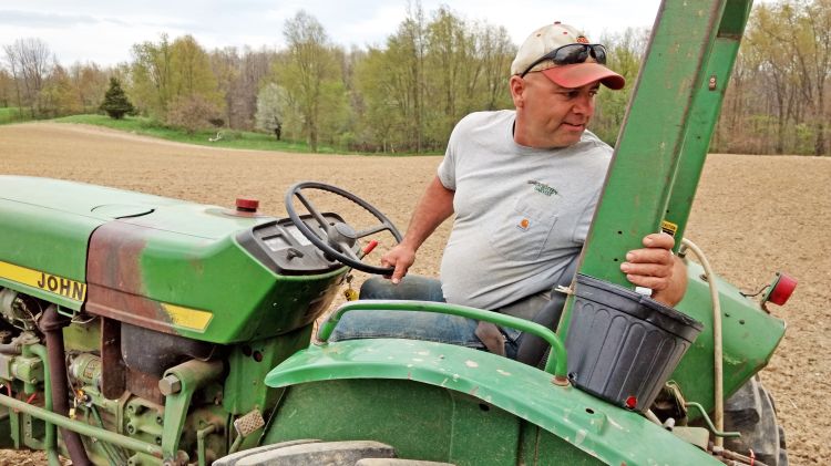 Mike Yancho, Jr., demonstrates proper technique. The hand at the bottom of the wheel helps prevent wiggly rows when looking backwards to check on staff and machinery in motion.