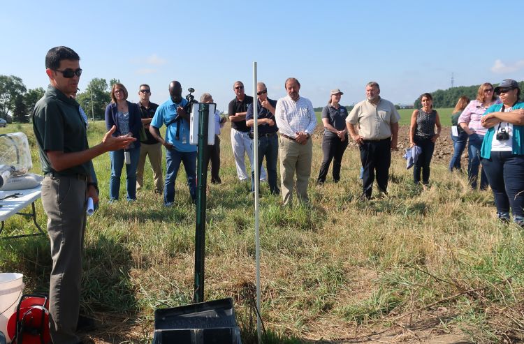 MSU Extension drainage specialist Ehsan Ghane (left) at a field day event in Lenawee County explaining conservation drainage practices.