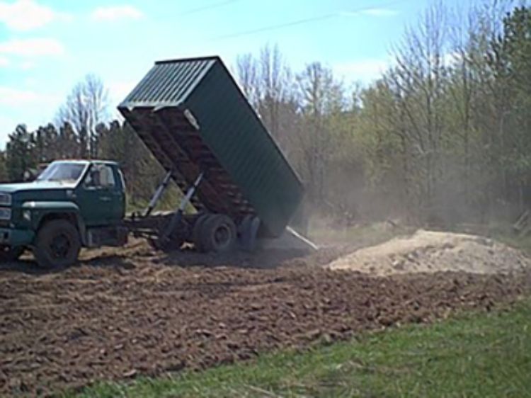 Dumping lime from truck in Ontonagon for MSU trial.
