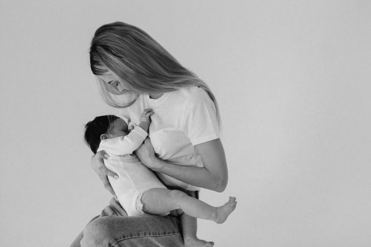 A black and white image of a breastfeeding parent.