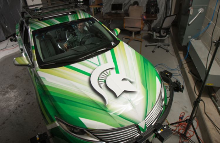 Photo of Hyder Radha, professor of Electrical And Computer Engineering, and Ph.d student Mohammed Al-Qizwini, working on an autonomous car at the Composite Vehicle Research Center.