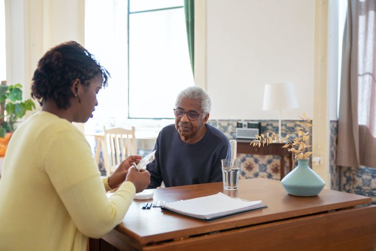 A woman caregiving for an older man.