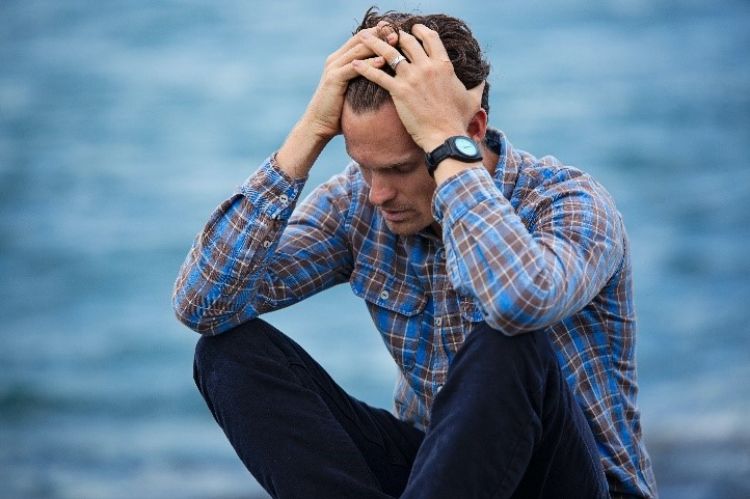 A man looking visibly stressed.