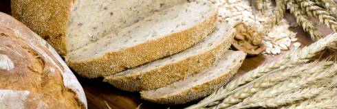 Fresh baked bread on a cutting board sliced.