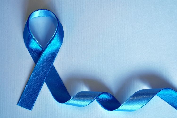 A photo of a blue ribbon on a white background.
