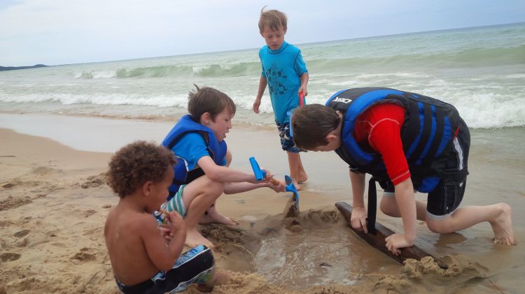 Children play on the shore of Lake Michigan. Photo by Monica Day