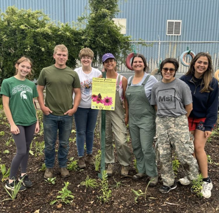 MSU affiliates Elizabeth Wing, Tyler Reisig, Charlie Rudolph, Karma Thomas, Jen Roedel, Ray Rantz and Cadillac Urban Gardens Co-Director Dolores Perales after planting on-farm wildflower habitat