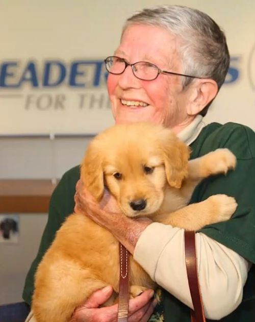 Nan with a retriever puppy.