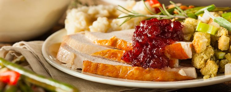 A plate of turkey and stuffing and potatoes.