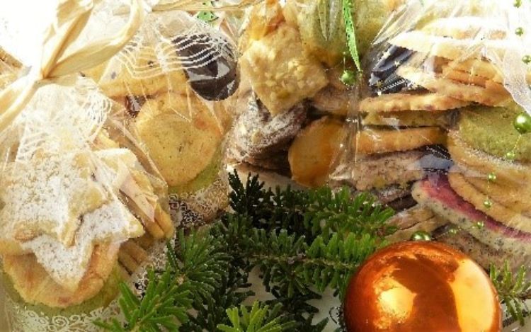 Various baked goods in bags surrounded by holiday decor.