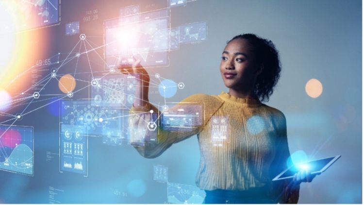 A woman interacts with a high tech digital interface.