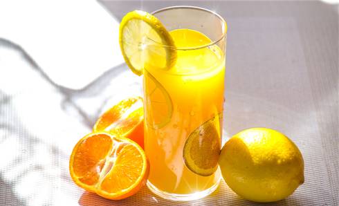glass of juice with fresh fruity around it