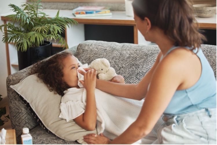 Photo of a woman taking care of a sick child.