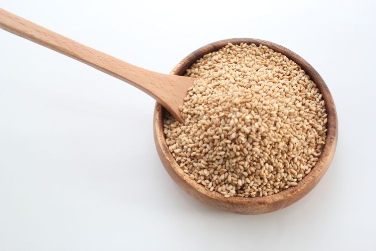 Wood bowl of sesame seeds.