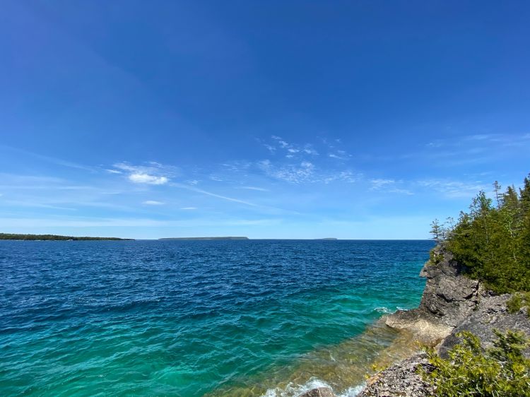 A look at a dark blue lake with a bright blue sky.