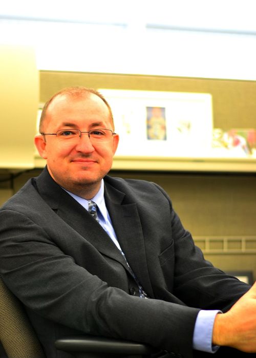 Ervin Currie, II sitting at a desk