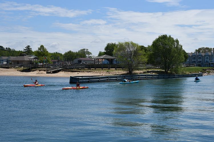 Kayakers are seen in a river.