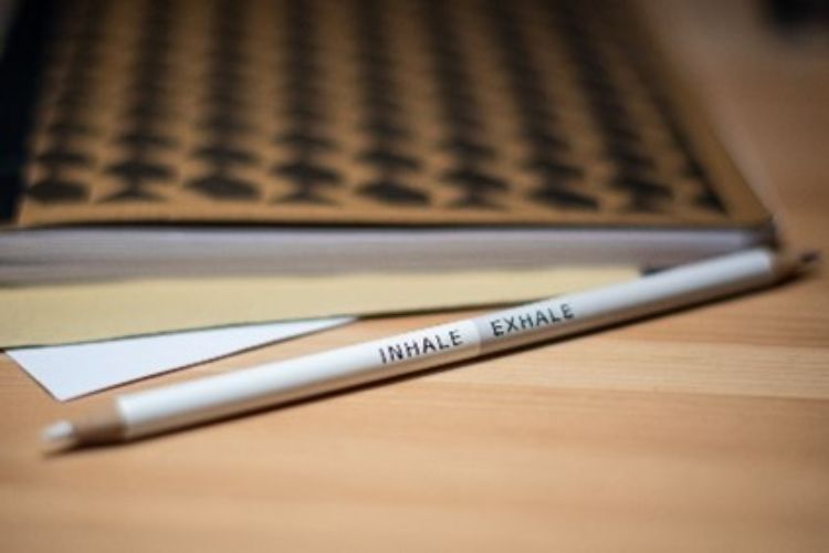 A white pencil on a desk.