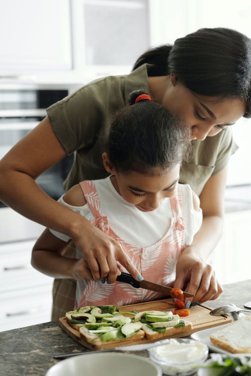 A mother and her child cooking.