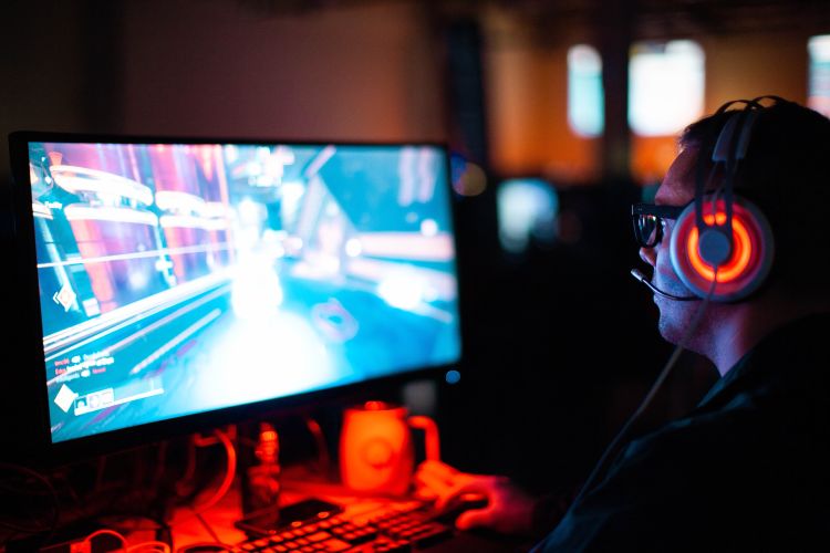 Man playing video games with headphones on.