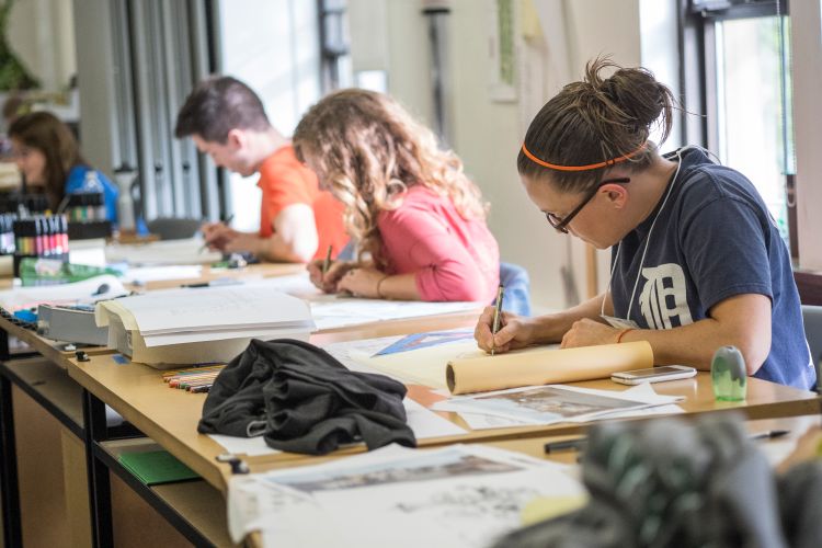 Students drawing landscape architecture plans in class.