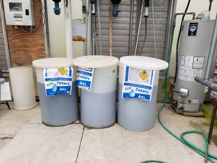 Tanks of water-soluble fertilizers in a greenhouse facility.