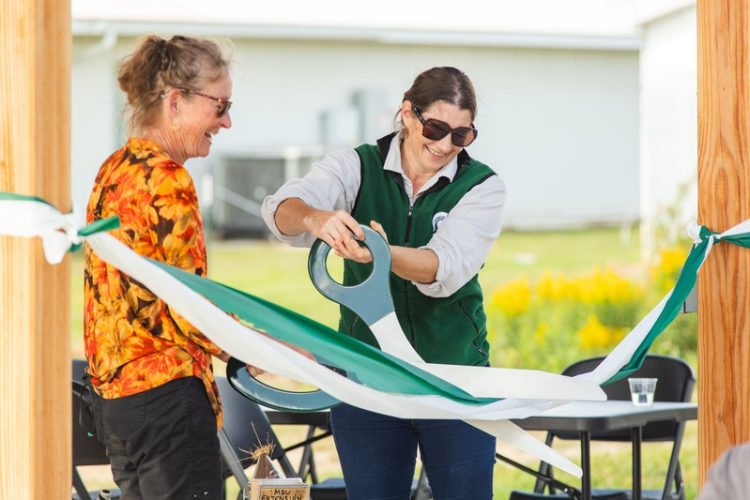 Dr. Meghan Milbrath and Charlotte Hubbard cutting the ribbon at the new MSU Pollinator Performance Center Teaching Pavilion. 