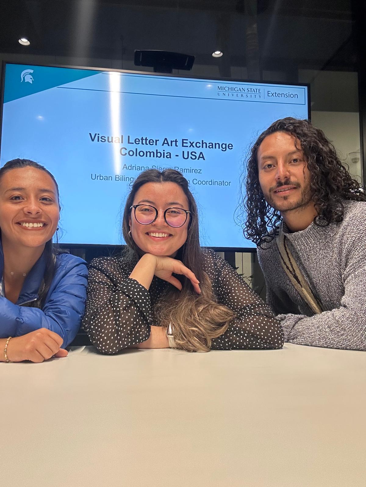 Three smiling individuals