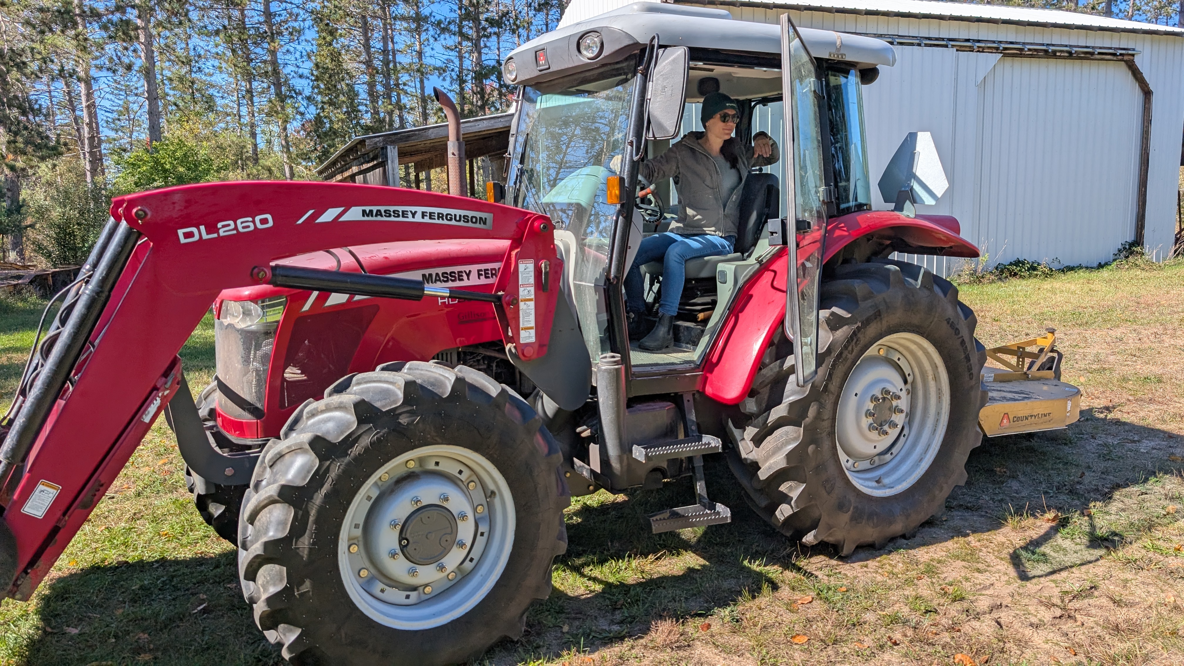 image of farmer seated in red tractor