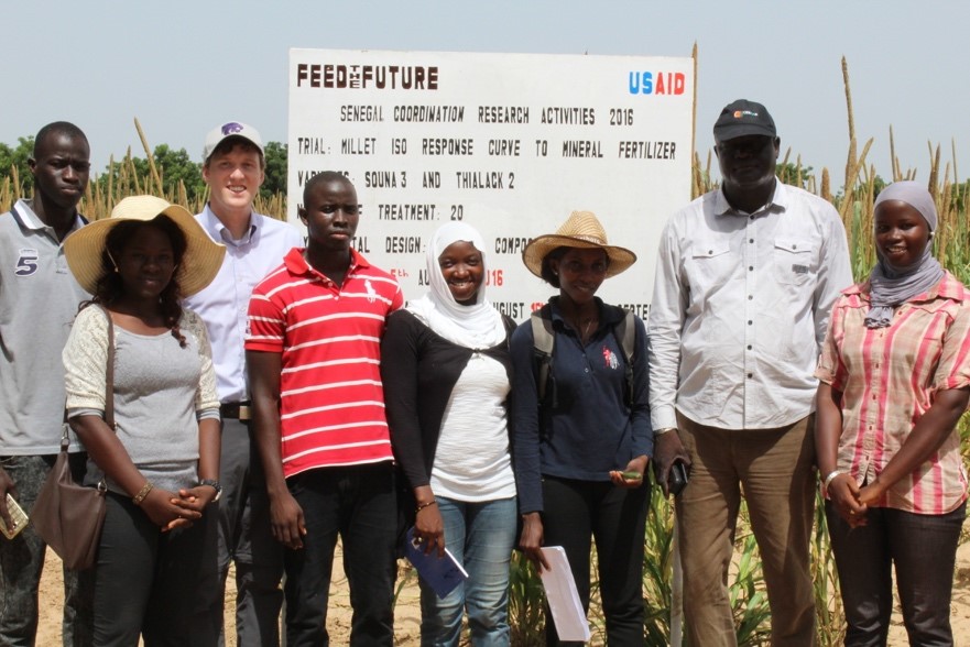 group of people standing infront of a white board