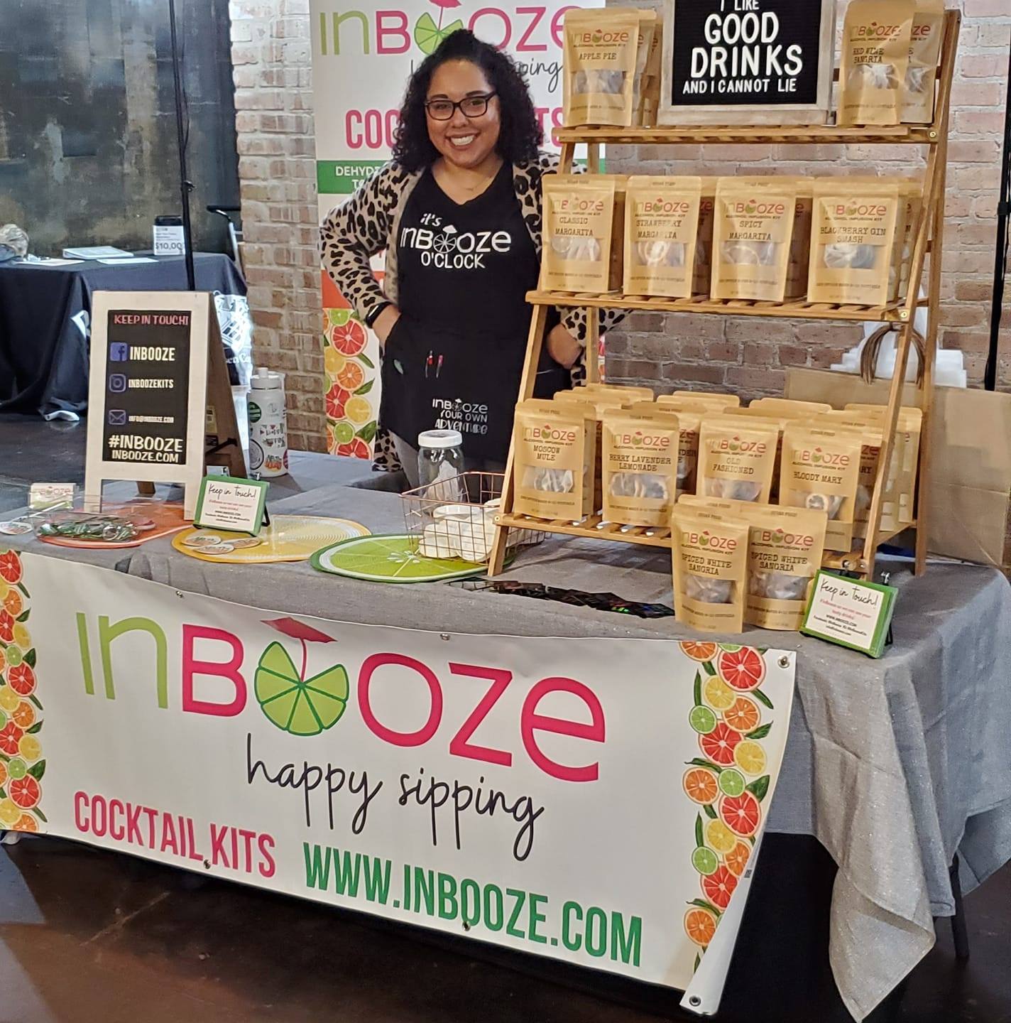 Ashleigh Evans standing in front of InBooze Cocktail Kits tradeshow booth.