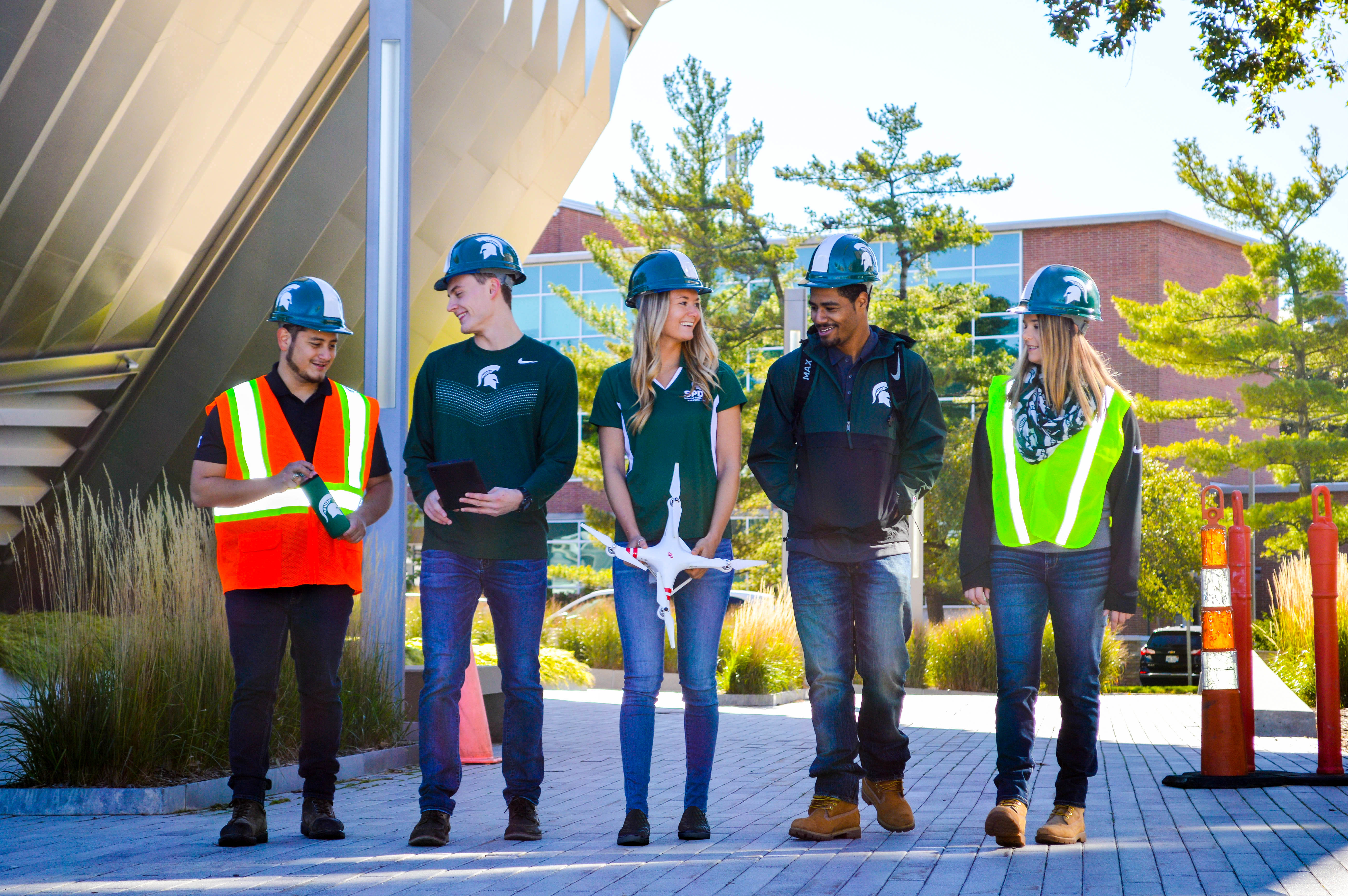 Construction management students walking together and talking.