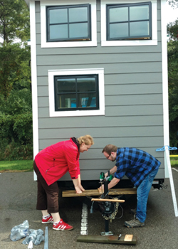 Rob Dalton and Sirle Salmistu installing the tongue deck for the mini-split compressor on Sparty's Cabin.